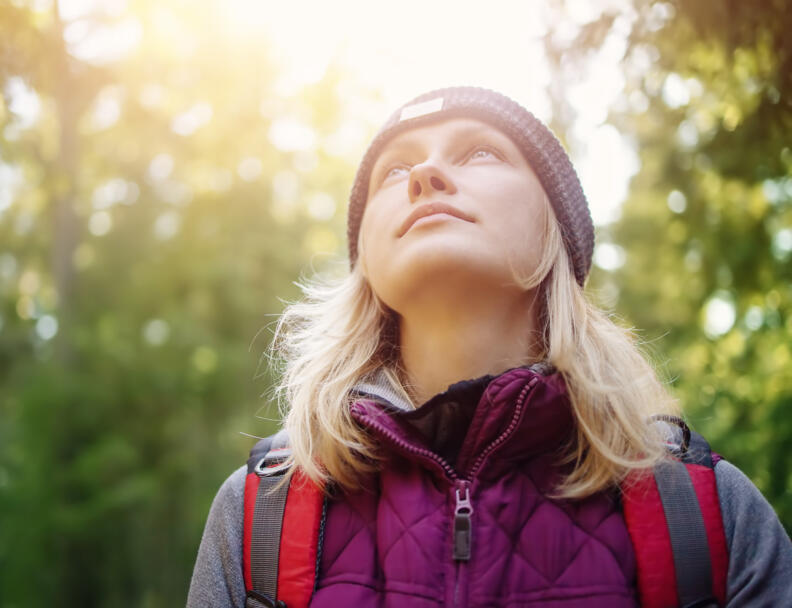 Young woman hiking and going camping in nature